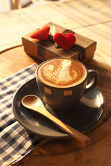 vintage color tone of  cup of coffee with red heart on the table