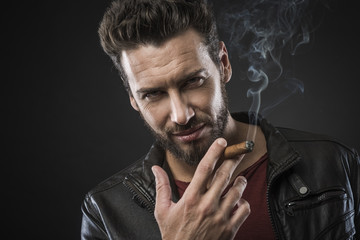 Confident fashionable man with cigar