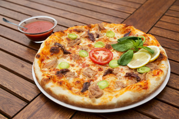 Delicious italian pizza served on wooden table