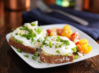 poached eggs and avocado on toast with tomatoestoes
