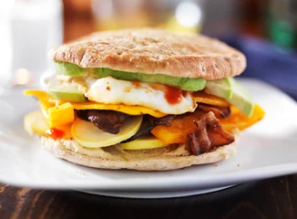 Zelfklevend Fotobehang breakfast sandwich with egg, bacon, avocado and vegetables © Joshua Resnick