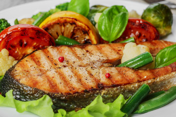 steak grilled salmon with vegetables on a plate