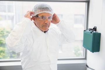 Pharmacist putting on his hairnet
