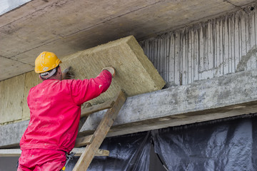 Man installing external wall insulation