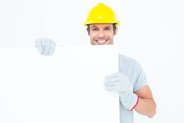 Happy architect with bill board over white background