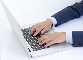 Businessman hands typing on laptop computer
