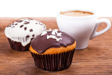 cup of coffee and two cupcakes