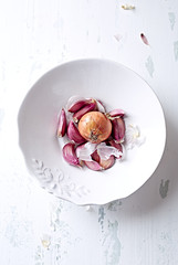 Garlic cloves and onion in a bowl