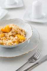 risotto with pumpkin in white bowl