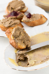 small bread pieces with homemade pate on white plate