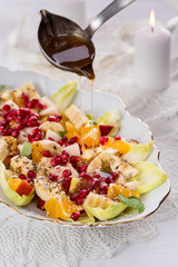 fruit and vegetable salad with sauce on white plate
