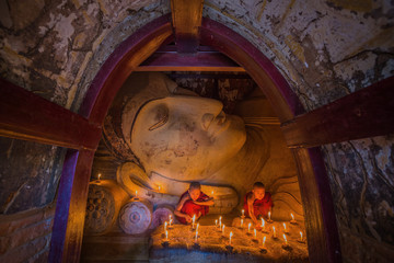 Buddhism monks praying with candle light at Shwesandaw temple