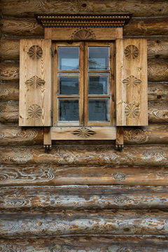 Windows with shutters, patterned on the wall of the old wooden h