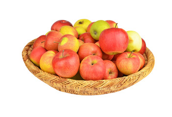 Red apple in a wattled basket, isolated on white background