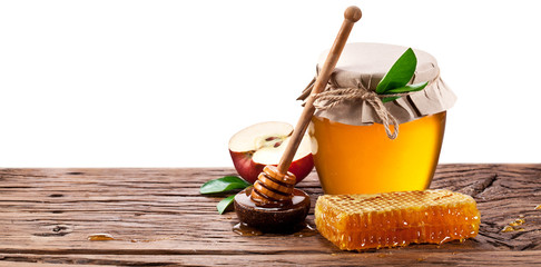 Glass can full of honey, apples  and on old wooden table. Clippi