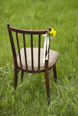 Close up of flower decorated on wedding vintage chair.