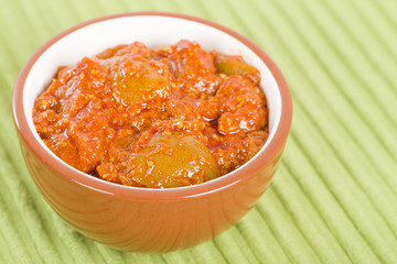 Lime Chutney - Indian lime pickle on a green background.