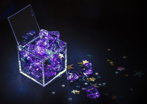 Plastic box filled with gems and stars