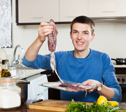 Ordinary smiling man with raw squid