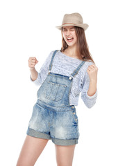 Young fashion girl in jeans overalls with yes gesture isolated