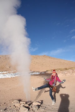 Young woman tourist at the Geyser in Bolivia 