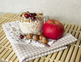 muesli with cranberries, apples and nuts in a glass