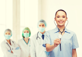 Fototapeta premium smiling female doctor or nurse with stethoscope