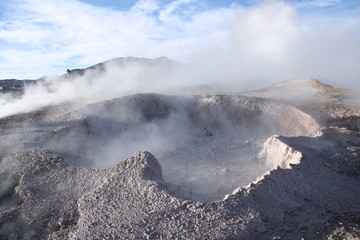 Geyser with mud and vapor above in Bolivia