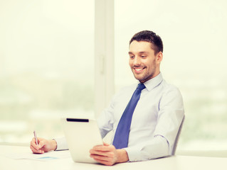 smiling businessman with tablet pc and documents