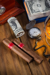 Top view, rich person or bussinesman desk with cuban cigar, bank