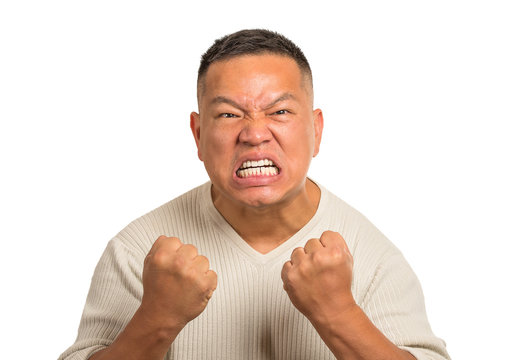 angry middle aged man with open mouth fist up in air