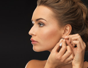 woman wearing shiny diamond earrings