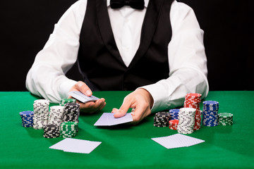 holdem dealer with playing cards and casino chips