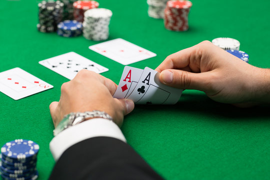 poker player with cards and chips at casino