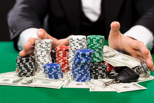 poker player with chips and money at casino table