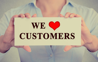 businesswoman hands holding sign message we love customers