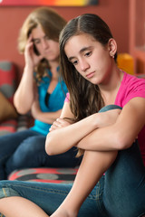 Sad teenage girl with her worried mother