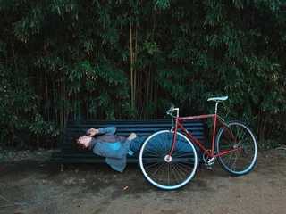 Tuinposter Man is laying on the bench and dreaming © BublikHaus