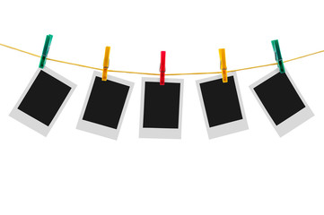 Five blank instant photos on clothesline