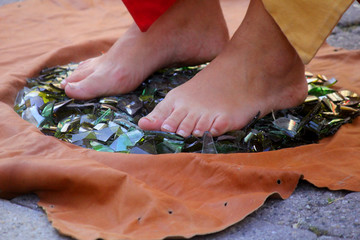feet on broken glasses