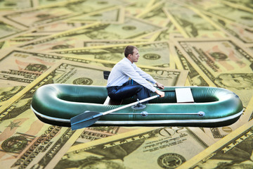 Image or photo of millionaire, human floats in rubber boat on mo