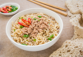 Instant noodles with pork in bowl
