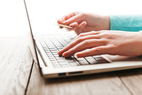 Female hands with credit card during shopping through Internet