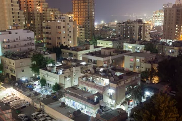 Photo sur Plexiglas moyen-Orient Residential buildings in Kuwait City at night
