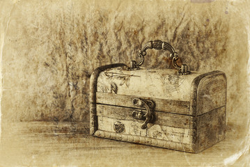 A collection of vintage jewelry in antique wooden jewelry box. r