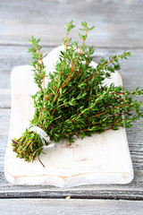 Fragrant thyme on a white chopping board