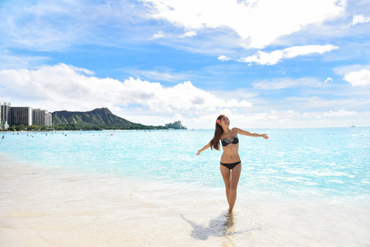 Happy beach woman in bikini on Waikiki Oahu Hawaii