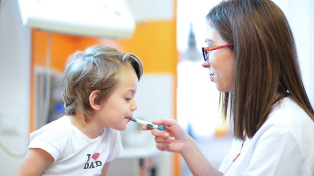 Cute boy being checked in throat