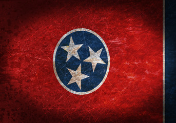 Old rusty metal sign with a flag