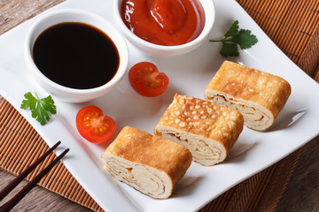 Japanese omelet tamago with sauce  horizontal top view